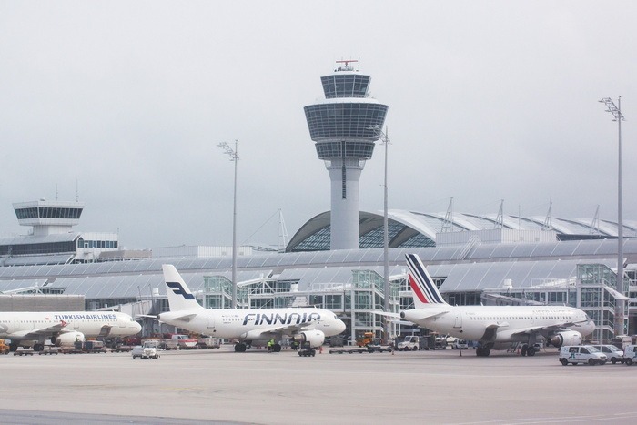 A picture of airplanes in front of an airport